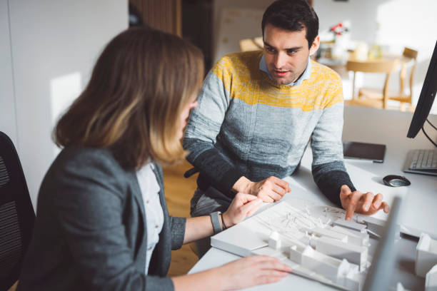 istock Architects discussing the details of a project 1338615780