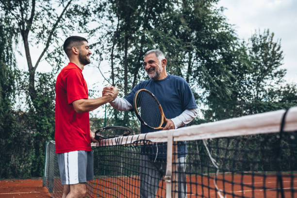 istock father and son playing tennis 1338619858