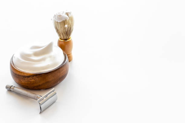 istock Shaving razor and foam in bowl - barber tools equipment 1338624156