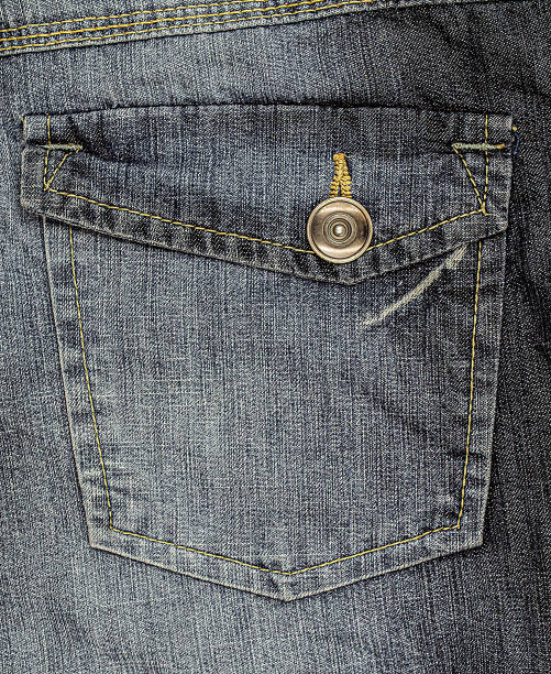istock Back pocket with button and yellow stitching stripes on denim 1338625870