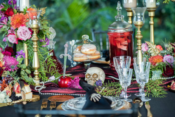 istock Table with skulls and tableware served for Halloween holiday 1338627533