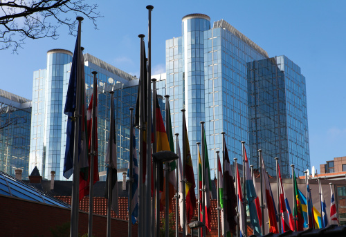 Flags of the member states of the European Union in front of the European Parliament building in Brussels, Belgium.