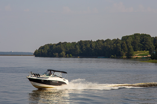 Volga River, Russia - August 09, 2021: Pleasure boat moves along the channel of the Volga river - River water transport