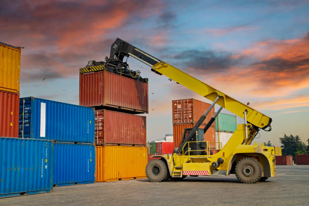 istock Crane lifting up container in a port. 1338632244