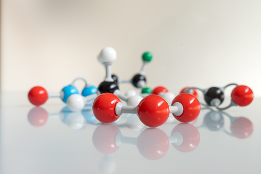 Close-up ozone molecule with differents greenhouse gases at the bottom. Chemical formula of O3 made by molecular model with nitrogen monoxide, carbon dioxide, methane, water and HFC - 125.