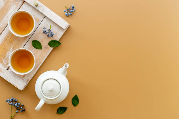 istock Ceramic white teapot and black tea in two cups, top view 1338632869