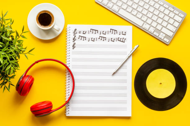 istock Compose music concept with music sheets and headphones, top view 1338633131