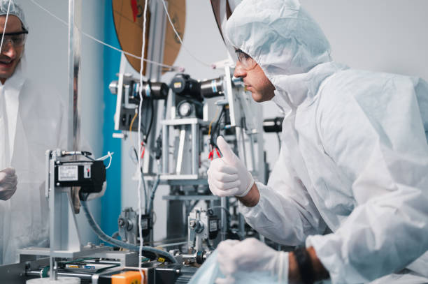 istock Two scientists wearing uniform protection. Check the manufacturing process face masks. With machinery in a laboratory at industry plants. The concept for security and protection coronavirus covid-19. 1338633892