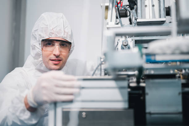 istock Scientists wearing protective clothing Inspect mask making machines in a laboratory at an industrial plant. Anti-virus production warehouse. concept of safety and prevention coronavirus covid-19. 1338634091