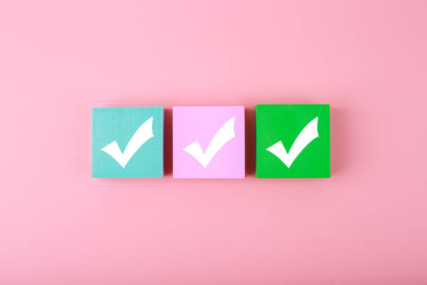 Three checkmarks top view on bright pastel pink  background with copy space. Concept of questionary, checklist, to do list, planning, business or verification.