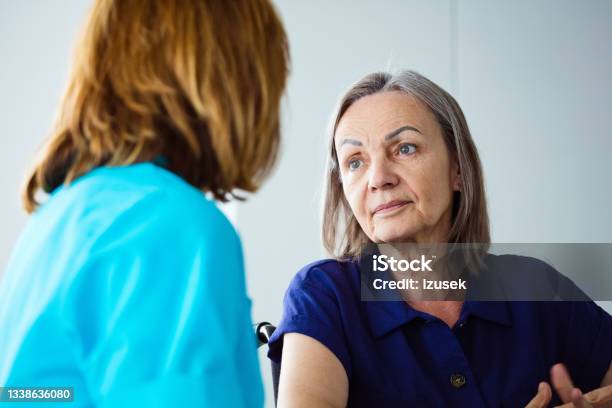 Depressed Senior Woman Talking With Nurse Stock Photo - Download Image Now - Alzheimer's Disease, Community Outreach, Healthcare Worker