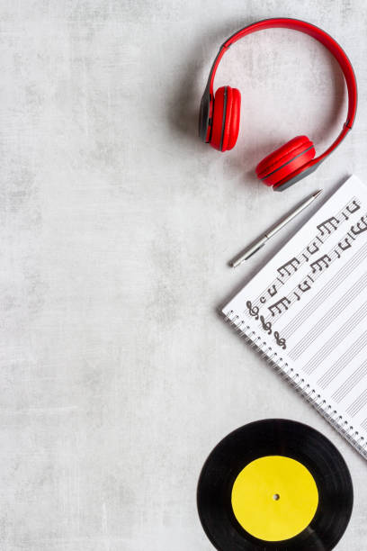 istock Music sheets with musical notes and headphones, top view 1338636162