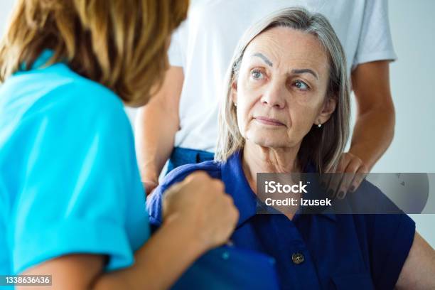 Worried Senior Woman Talking With Nurse Stock Photo - Download Image Now - Human Face, Paralysis, Patient