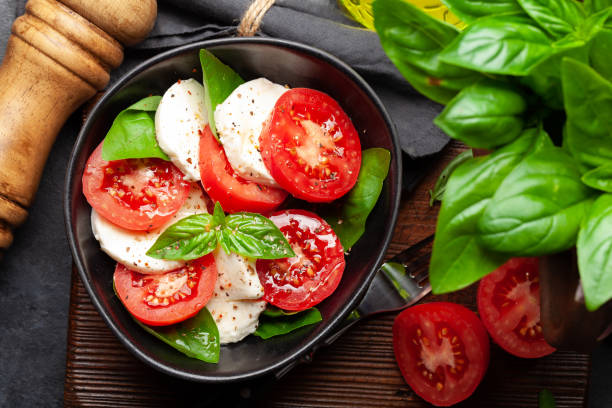 istock Caprese salad with fresh tomatoes, garden basil and mozzarella cheese 1338638196