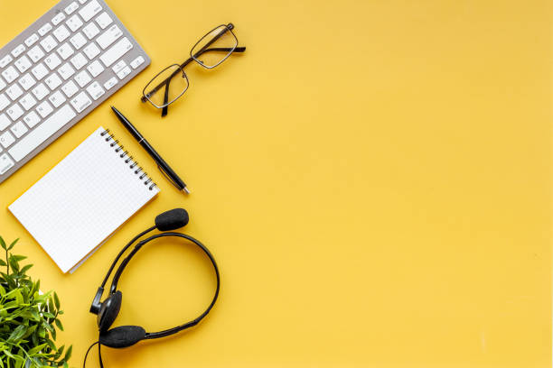 istock Office desk with headset and pc call center support 1338641732