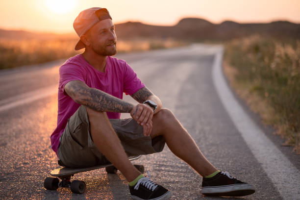 istock Young Caucasian man skating on an open road 1338644927