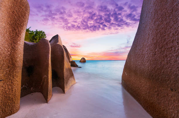 Anse Source d'Argent beach in the Seychelles at sunset Beautifully shaped granite boulders and a dramatic sunset  at Anse Source d'Argent beach, La Digue island, Seychelles indian ocean stock pictures, royalty-free photos & images