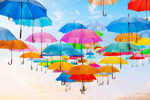 paraguas de colores en el cielo. - colors color image rainbow umbrella fotografías e imágenes de stock