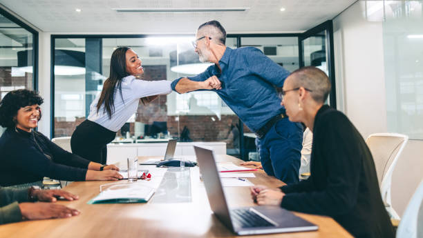istock Modern businesspeople elbow bumping each other before a meeting 1338649147