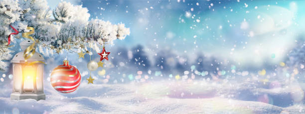 istock Snow-covered spruce branch on background of blue evening sky, falling flakes snow. 1338650563