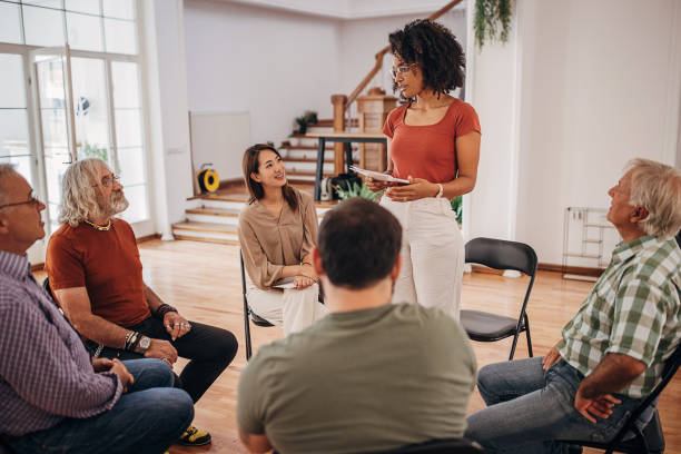 istock Female therapist talking at support group therapy 1338650713