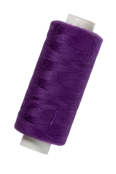 istock Spool of purple sewing thread close up isolated on white 1338654135