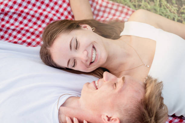 istock Young couple cuddling on a picnic blanket 1338660141