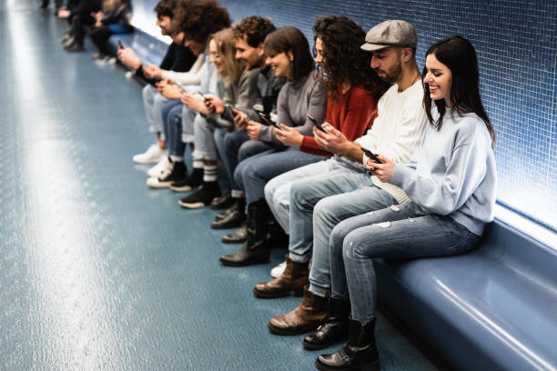 istock Young multiracial friends having fun using mobile phones inside subway station - Focus on right woman face 1338663255