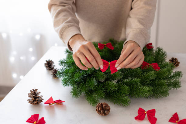 istock female hands decorating Christmas wreath 1338667738