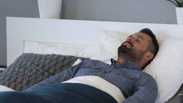 istock Online Shopping on Tablet by Tired Man in Bed 1338667846