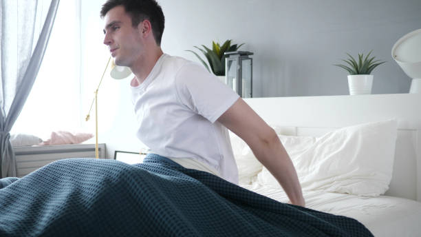 istock Fresh Man Waking Up From Sleep in Bed 1338670203