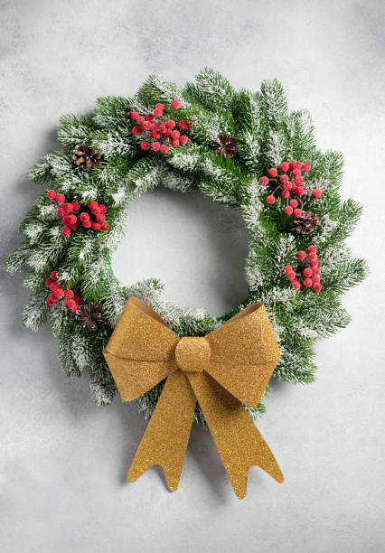 istock Christmas wreath with ornaments on gray wall 1338670482