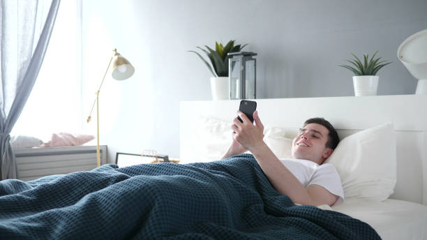 istock Online Video Chat on Smartphone in Bed 1338671623