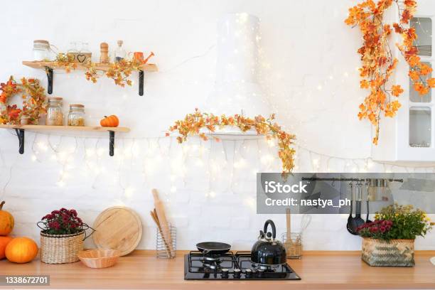 Golden Leaves And A Pumpkin On White Kitchen In The Scandinavian Style The Concept Of Home Comfort Autumn Decor For The Halloween Holiday Stock Photo - Download Image Now