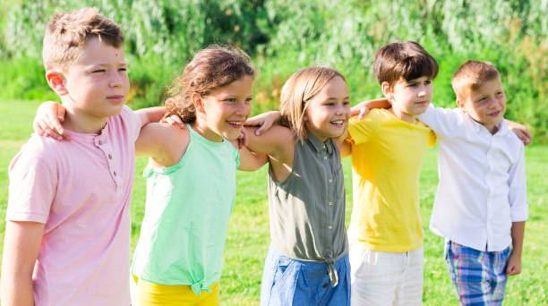 Portrait of five glad children who are walking and posing in park Portrait of five glad children who are walking and posing in the park child 10 11 years 8 9 years cheerful stock pictures, royalty-free photos & images