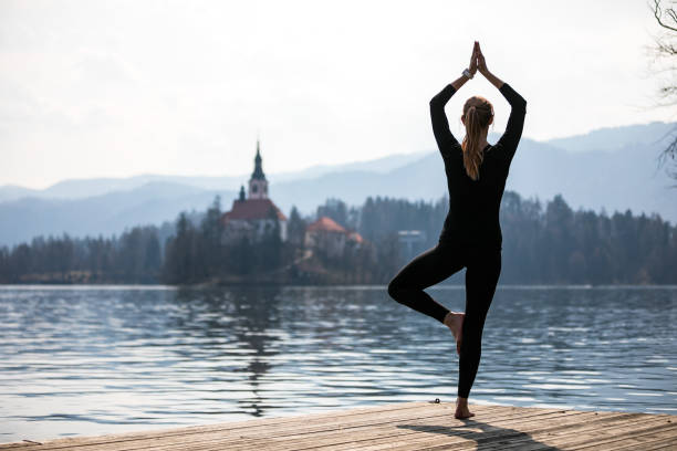 istock Yoga Tree Pose Outdoors at Lake Bled 1338673860