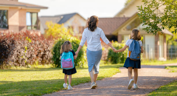 istock Parent and pupils going to school 1338673983