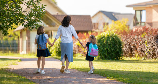 istock Parent and pupils going to school 1338673986
