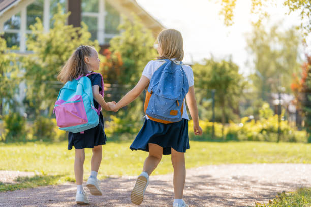 istock Girls with backpack are going to school 1338674054