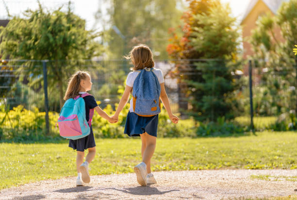 istock Girls with backpack are going to school 1338674066