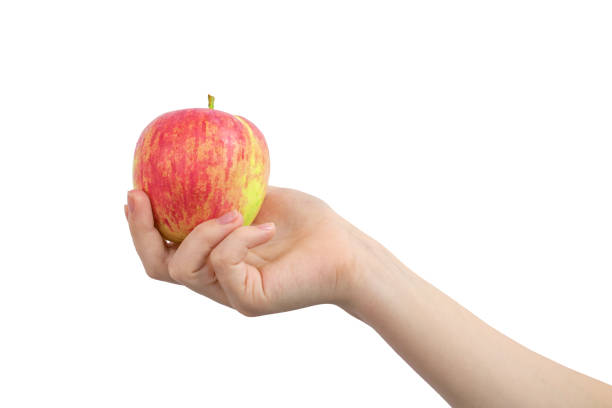 istock Red apple in hand, isolated on a white background photo 1338677922