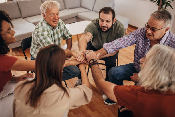 istock People holding hands together in support group therapy 1338678396