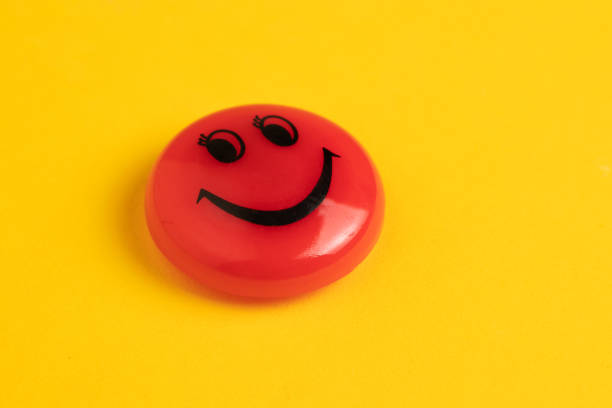 istock Red magnet smile - holders on a yellow background 1338682634