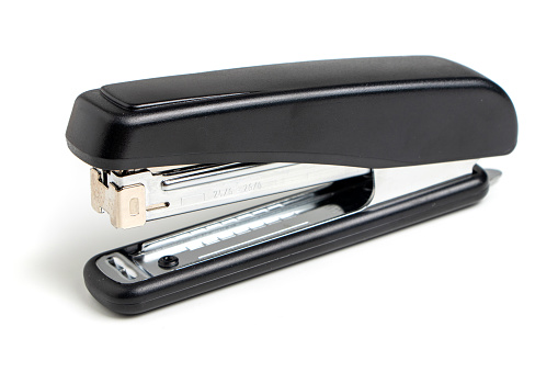 Black professional stapler isolated on white background.