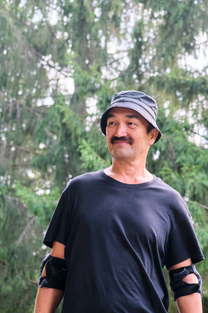 istock Active senior asian smiling man doing sports in park. 1338684318