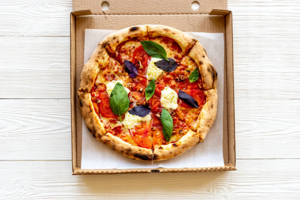 Margherita italian pizza with tomatoes cheese and basil, top view