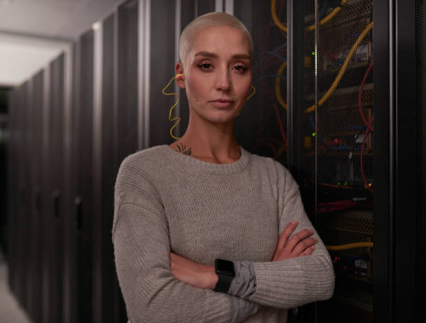 istock Shot of a young female engineer working in a server room 1338686575