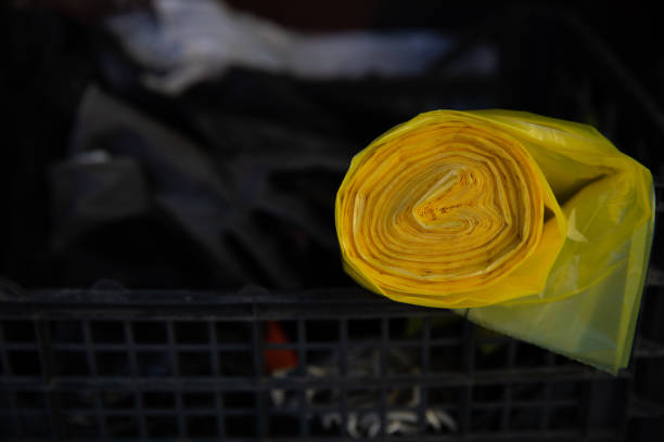 Yellow plastic bag in box with garden tools