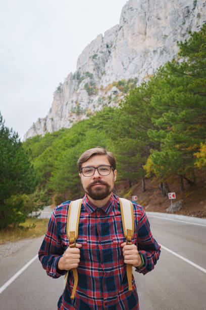 istock Travel man with backpack hiking in the mountains 1338686997