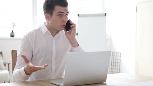 istock Businessman in Anger Talking on Phone, Yelling and Fighting 1338688391